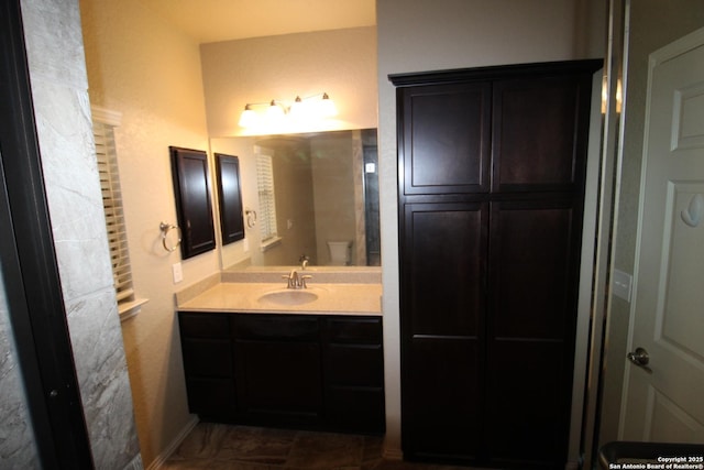 bathroom featuring toilet and vanity