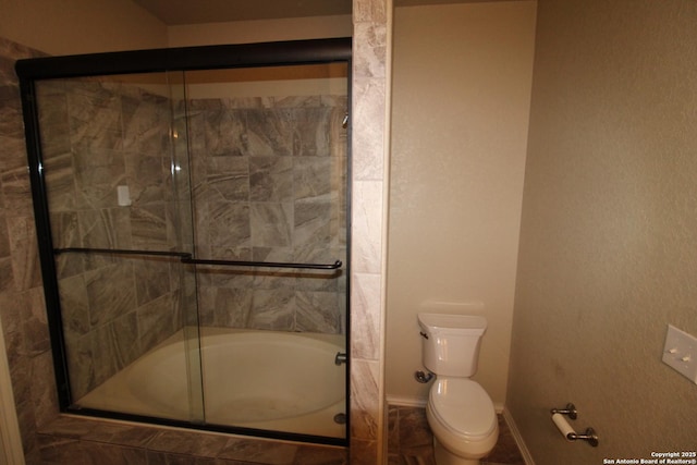 bathroom featuring baseboards and toilet