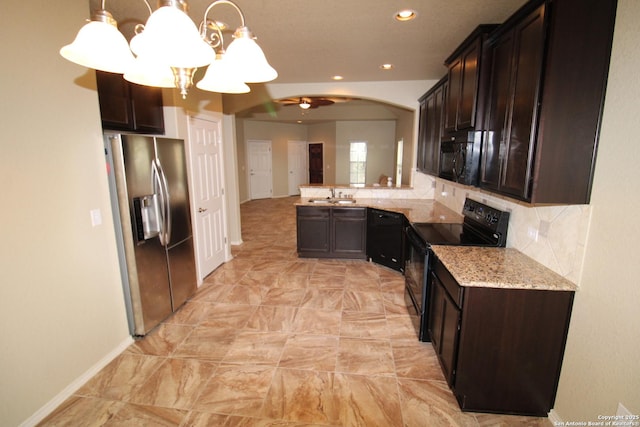 kitchen featuring black appliances, dark brown cabinets, a sink, and pendant lighting