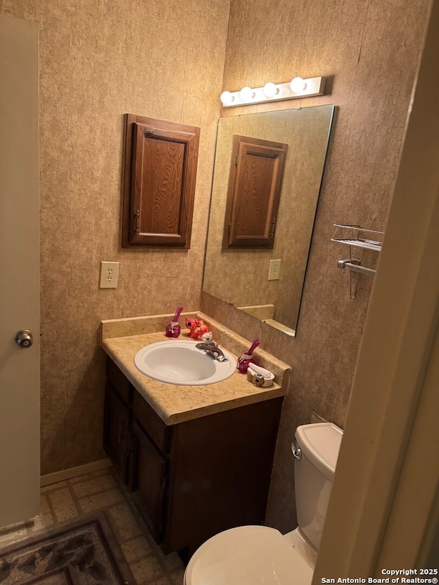 half bathroom with toilet and vanity