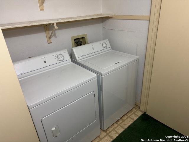 washroom featuring light floors and separate washer and dryer