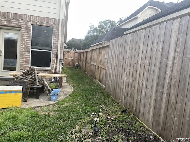 view of yard with a patio and a fenced backyard