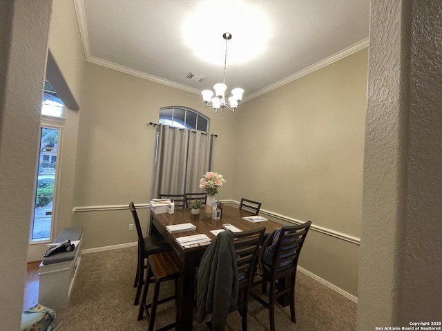 dining room with baseboards, visible vents, ornamental molding, dark colored carpet, and a chandelier