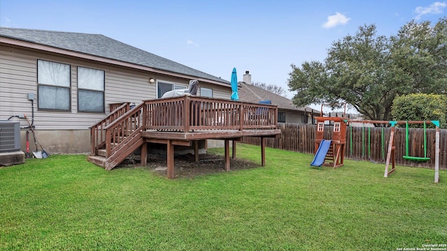 exterior space with a lawn, fence, a deck, central air condition unit, and a playground