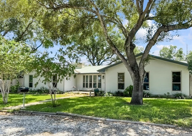 single story home featuring a front yard and a chimney