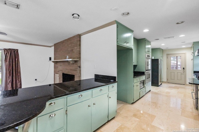 kitchen featuring dark stone countertops, crown molding, visible vents, and green cabinetry