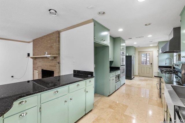 kitchen featuring visible vents, exhaust hood, dark stone countertops, green cabinetry, and recessed lighting