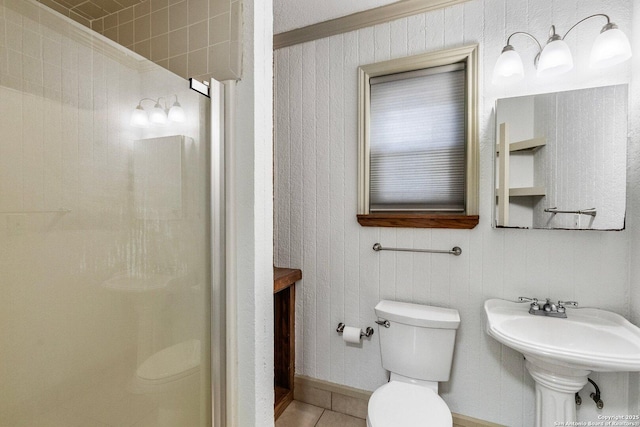 full bathroom with tile patterned flooring, toilet, baseboards, ornamental molding, and a stall shower