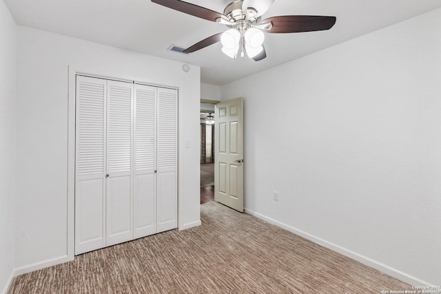 unfurnished bedroom with light carpet, baseboards, visible vents, ceiling fan, and a closet