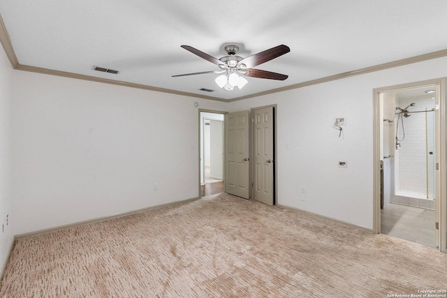 unfurnished bedroom featuring visible vents, crown molding, and light colored carpet