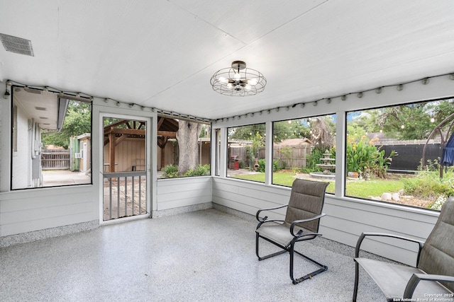 unfurnished sunroom featuring visible vents