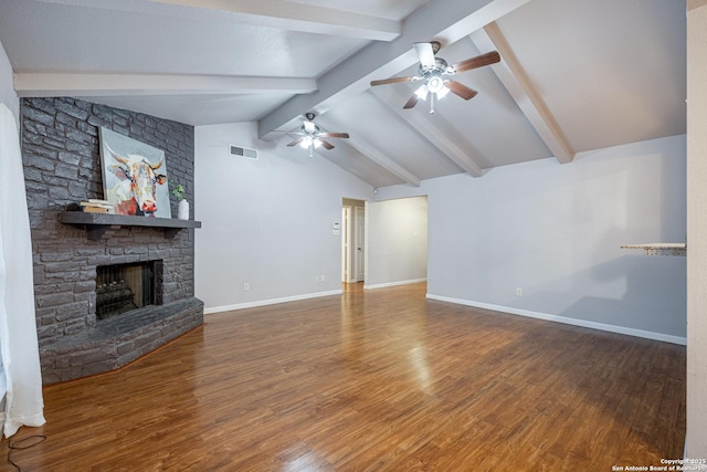 unfurnished living room featuring ceiling fan, wood finished floors, a stone fireplace, and visible vents