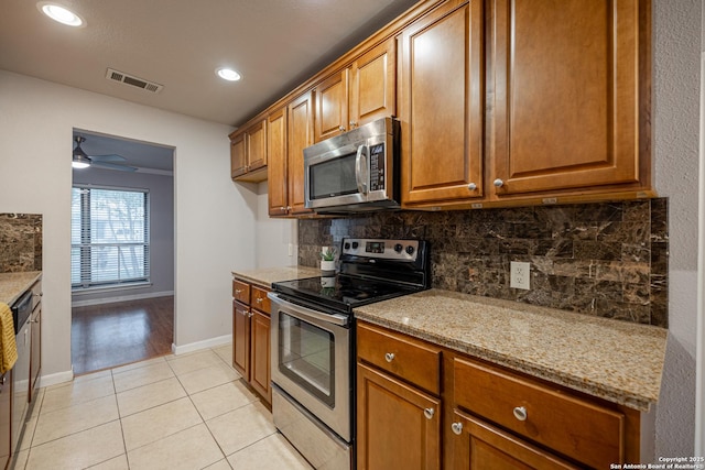 kitchen with backsplash, brown cabinetry, visible vents, and stainless steel appliances