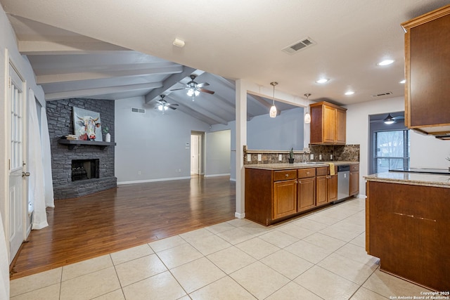 kitchen with visible vents, a ceiling fan, light tile patterned floors, decorative backsplash, and brown cabinetry