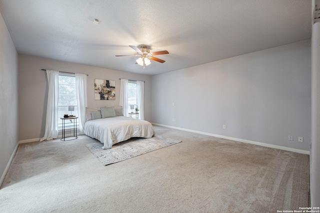 carpeted bedroom with baseboards and ceiling fan