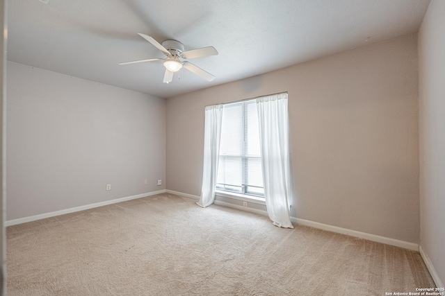 unfurnished room featuring light carpet, a ceiling fan, and baseboards