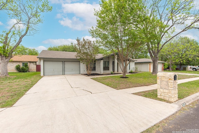 mid-century inspired home featuring driveway, a front lawn, brick siding, and a garage