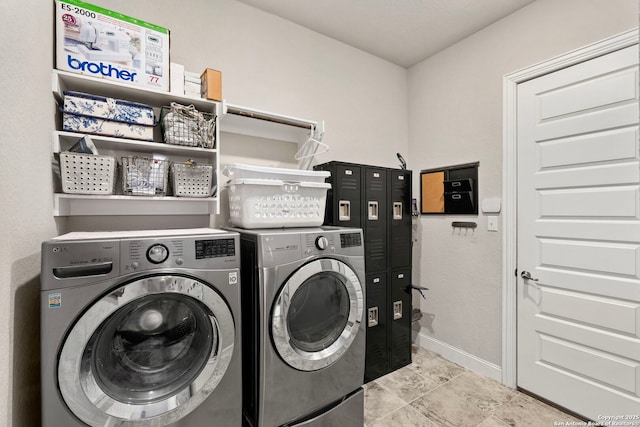 laundry room featuring laundry area, baseboards, and washer and dryer