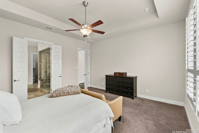 bedroom featuring carpet, a raised ceiling, visible vents, and baseboards