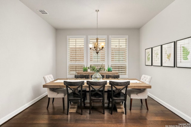 dining space with an inviting chandelier, baseboards, visible vents, and dark wood-style flooring