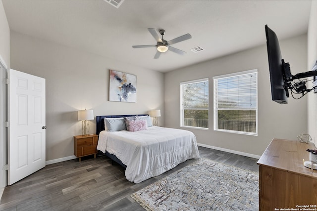 bedroom with dark wood-style flooring, visible vents, ceiling fan, and baseboards