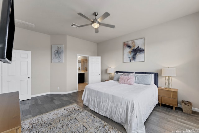 bedroom featuring visible vents, a ceiling fan, connected bathroom, wood finished floors, and baseboards