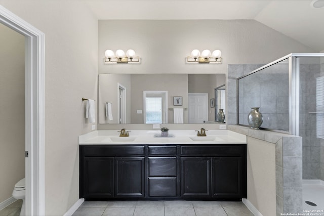 bathroom featuring lofted ceiling, a shower stall, toilet, and a sink