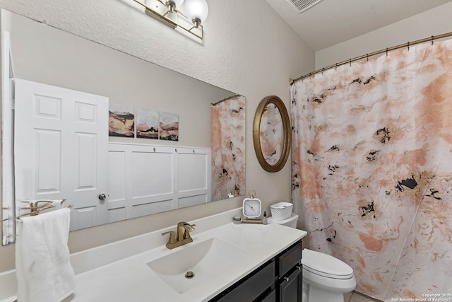 full bath featuring visible vents, vanity, and toilet