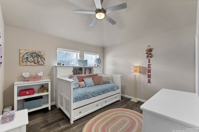 bedroom featuring lofted ceiling, ceiling fan, baseboards, and dark wood-type flooring