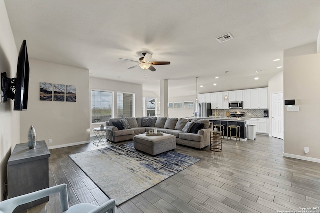 living area featuring wood finish floors, recessed lighting, visible vents, ceiling fan, and baseboards