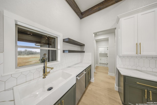 kitchen featuring a sink, white cabinetry, light stone counters, and dishwasher