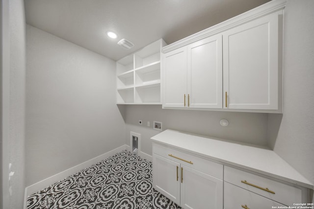 washroom featuring hookup for a washing machine, cabinet space, light tile patterned flooring, electric dryer hookup, and baseboards