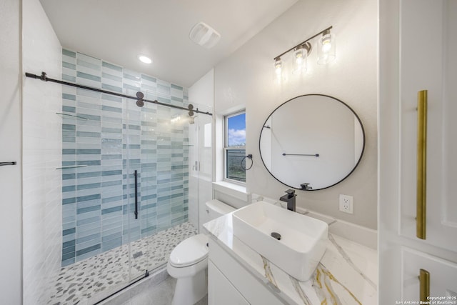 bathroom featuring visible vents, toilet, vanity, and a shower stall