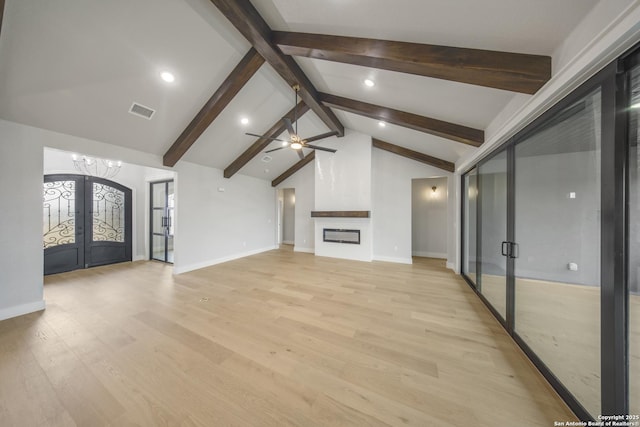 unfurnished living room featuring french doors, a fireplace, visible vents, light wood-style floors, and beamed ceiling