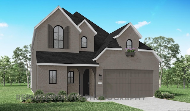 french country home featuring a garage, brick siding, a shingled roof, concrete driveway, and a front yard