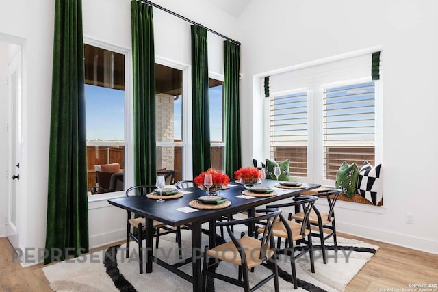 dining room with baseboards and wood finished floors