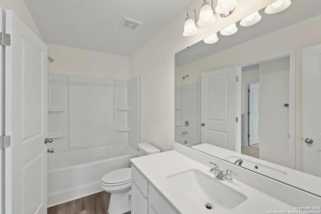 full bath featuring shower / bath combination, visible vents, toilet, vanity, and wood finished floors