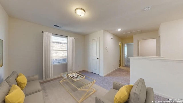 living area featuring light colored carpet, visible vents, and baseboards