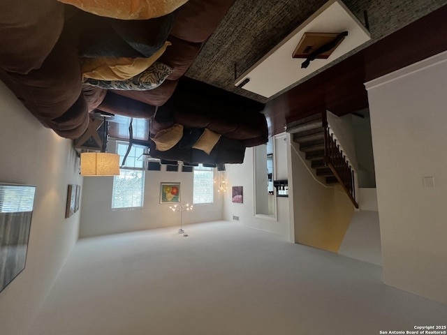 unfurnished living room with stairway