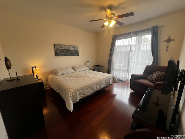 bedroom featuring access to exterior, dark wood-type flooring, and a ceiling fan