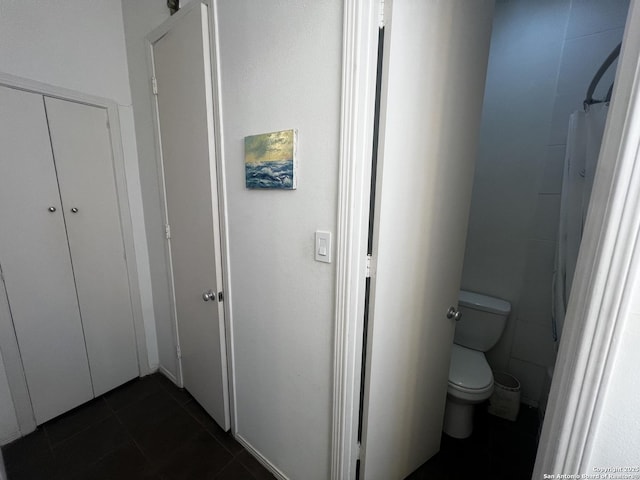 bathroom featuring toilet and tile patterned floors