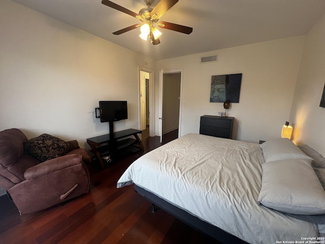 bedroom with dark wood-style floors, ceiling fan, and visible vents