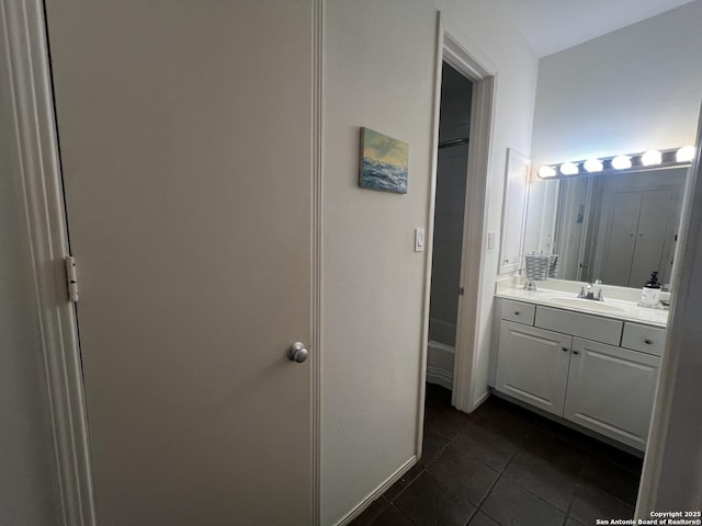 full bath with vanity, baseboards, and tile patterned floors