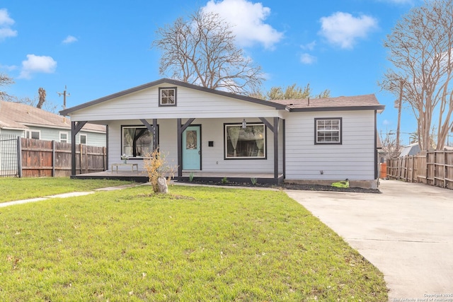 view of front of home with fence, a porch, and a front yard