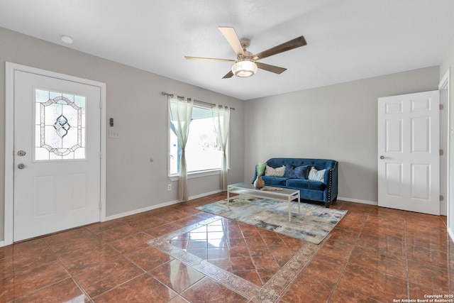 entrance foyer with a ceiling fan and baseboards