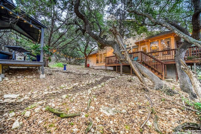 view of yard featuring stairway and a wooden deck