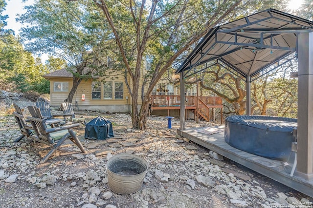 view of yard featuring stairs, a gazebo, an outdoor fire pit, and a wooden deck