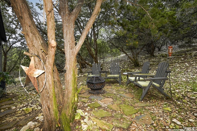 view of yard featuring a patio and an outdoor fire pit