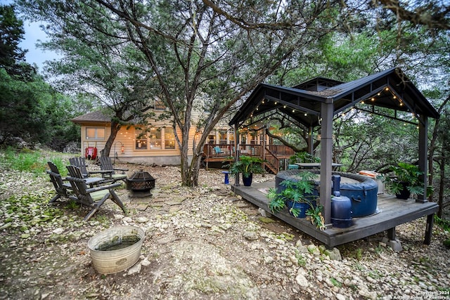 view of yard featuring a fire pit and a wooden deck