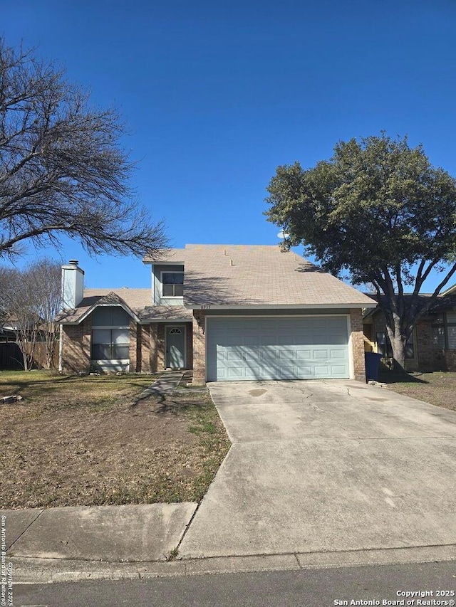 view of front of property featuring brick siding, driveway, and an attached garage